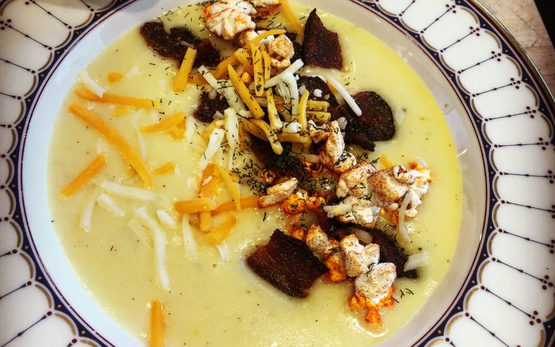 Beer cheese soup with spiced popcorn, bacon, and more beer